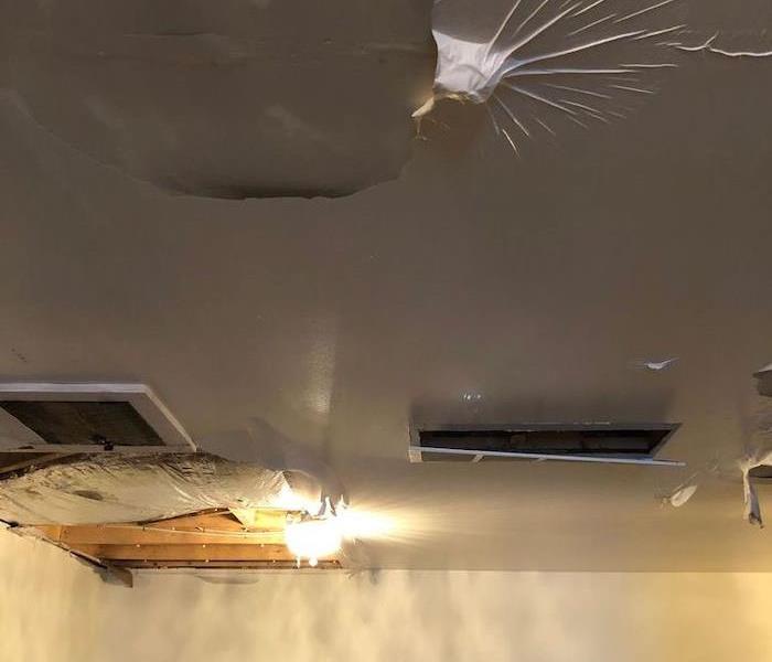 Ceiling with water damage and paint bubbles
